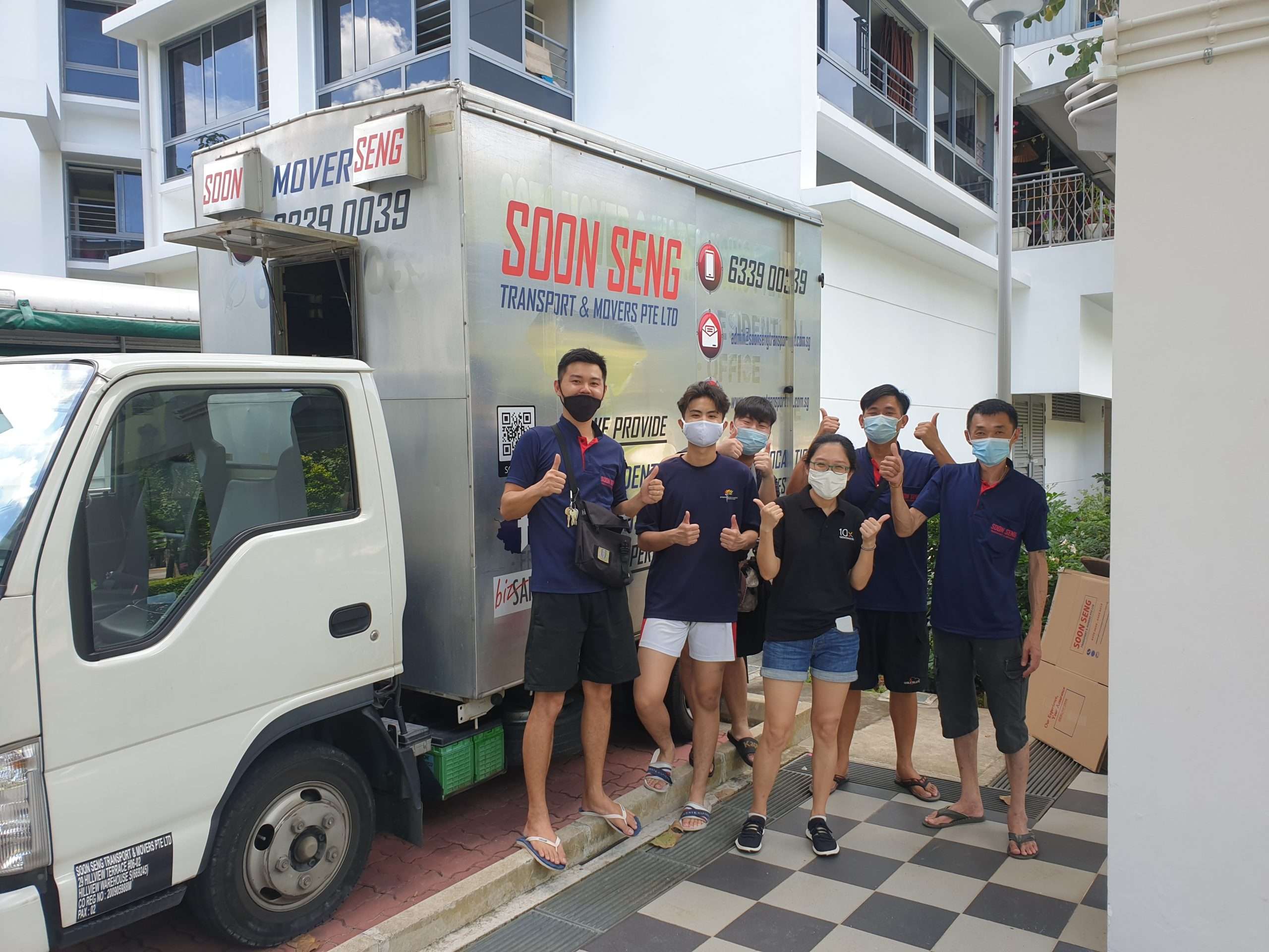 soon seng group photo with client beside truck