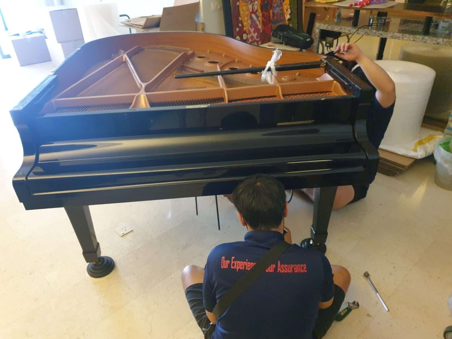 2 man assembling piano