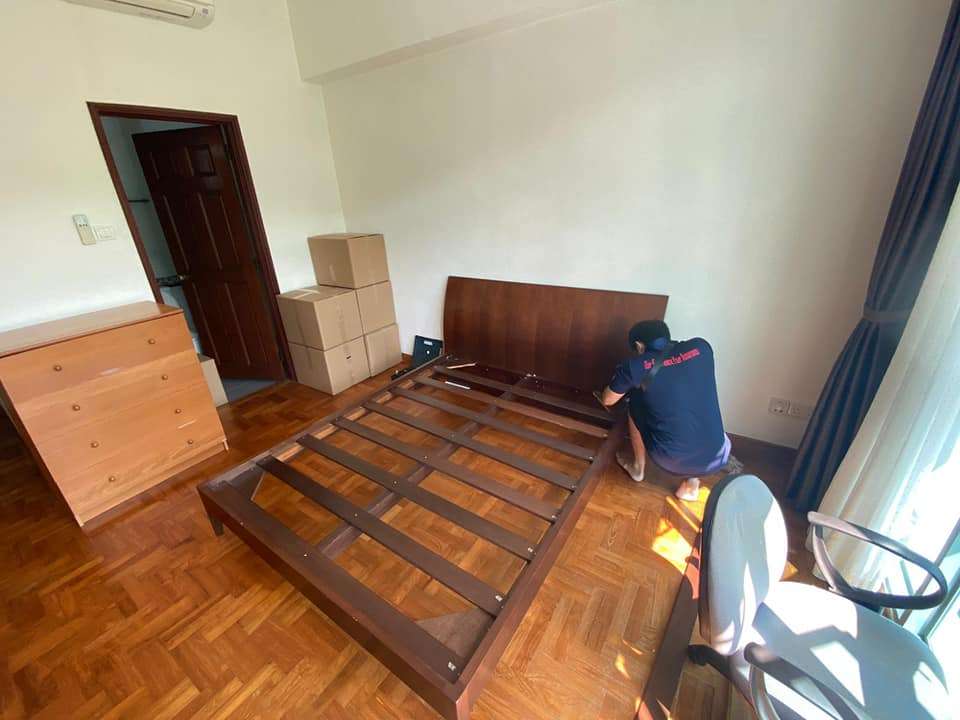 bedframe being dissembled by home mover