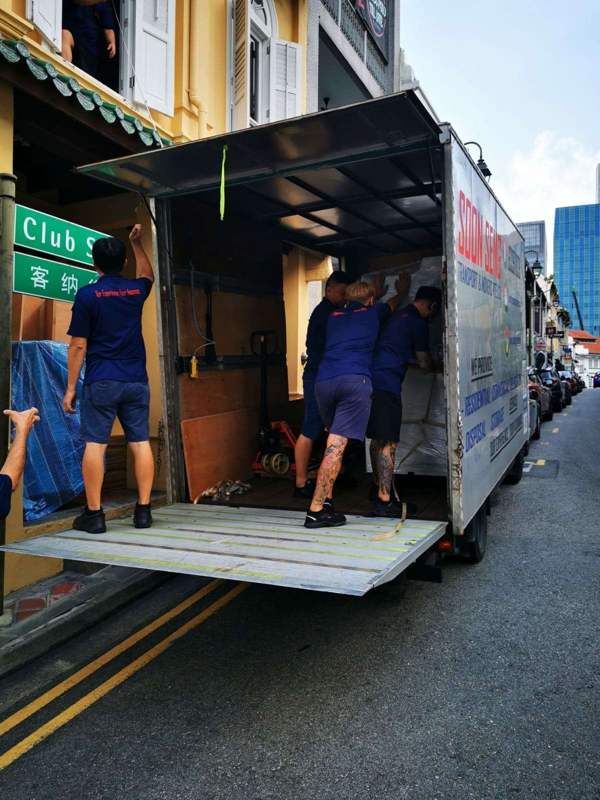 staff moving office equipment onto truck