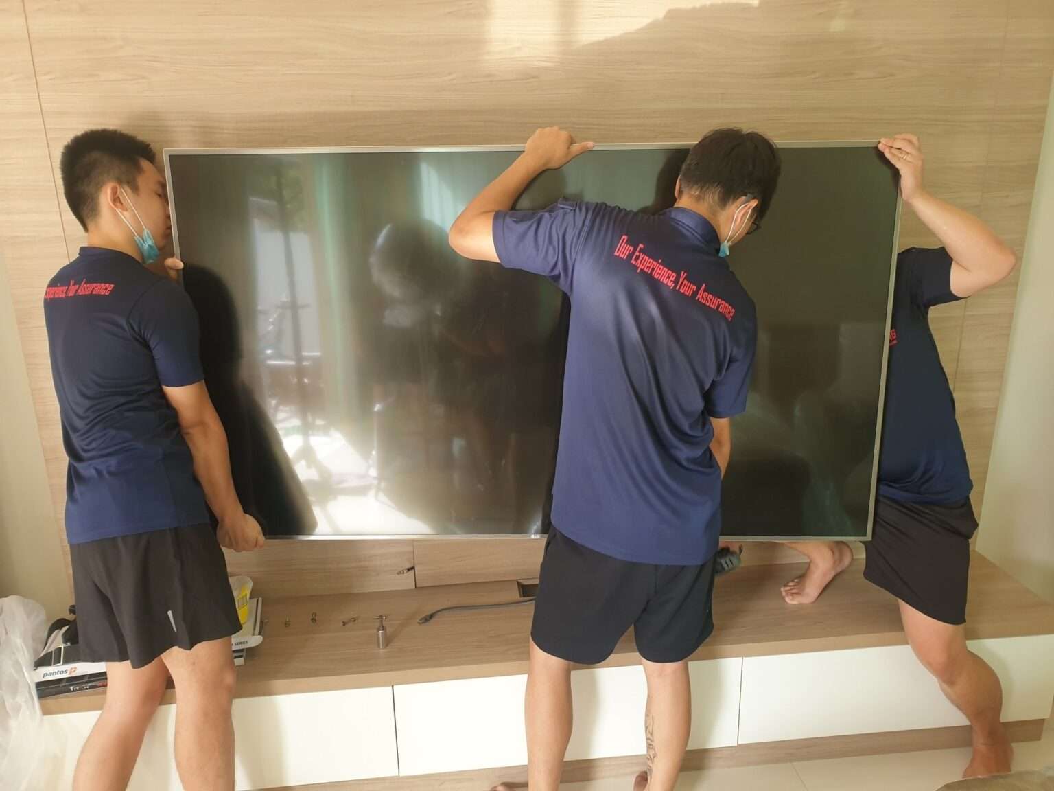 home movers placing tv in new home