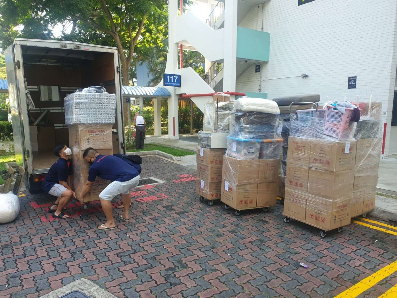 movers lifting heavy item into the truck