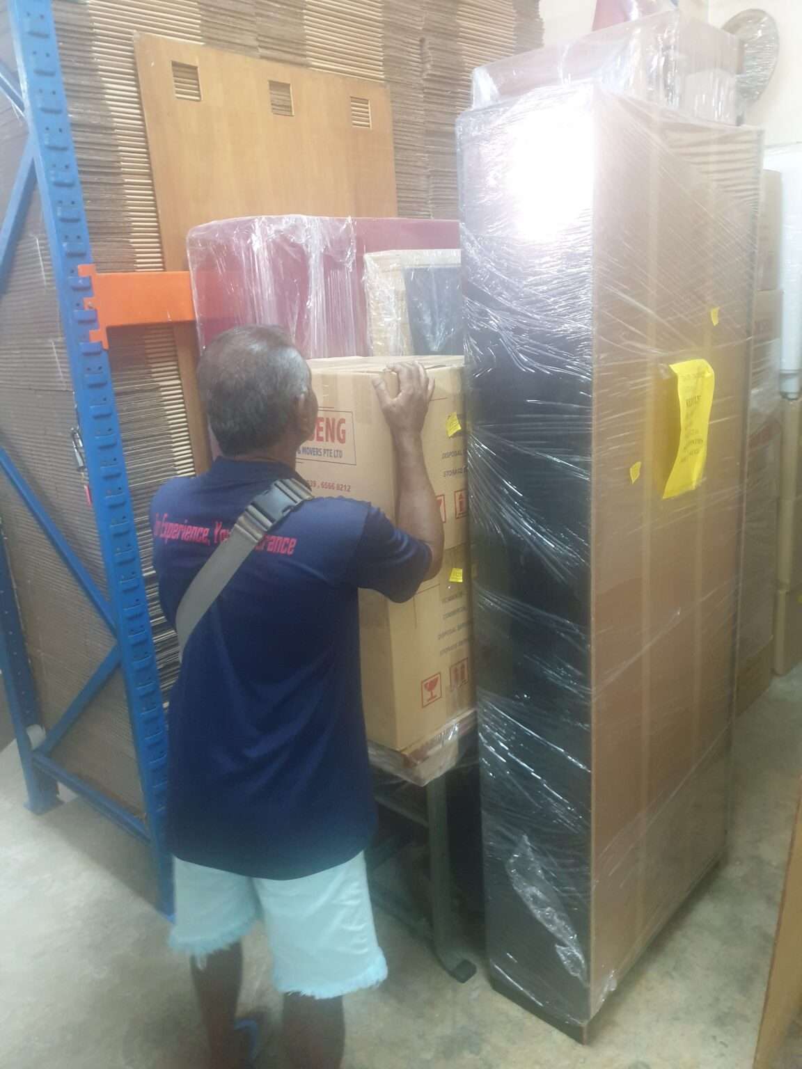 movers putting in boxes in storage
