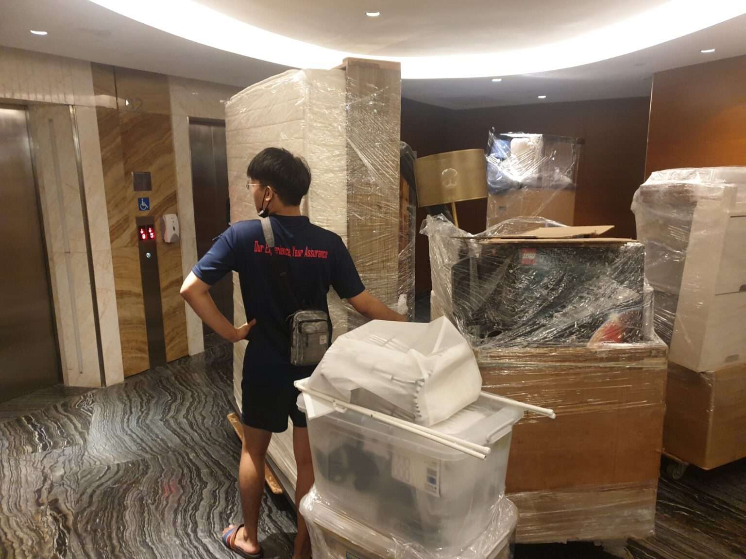 movers waiting for elevator to transport furnitures and item