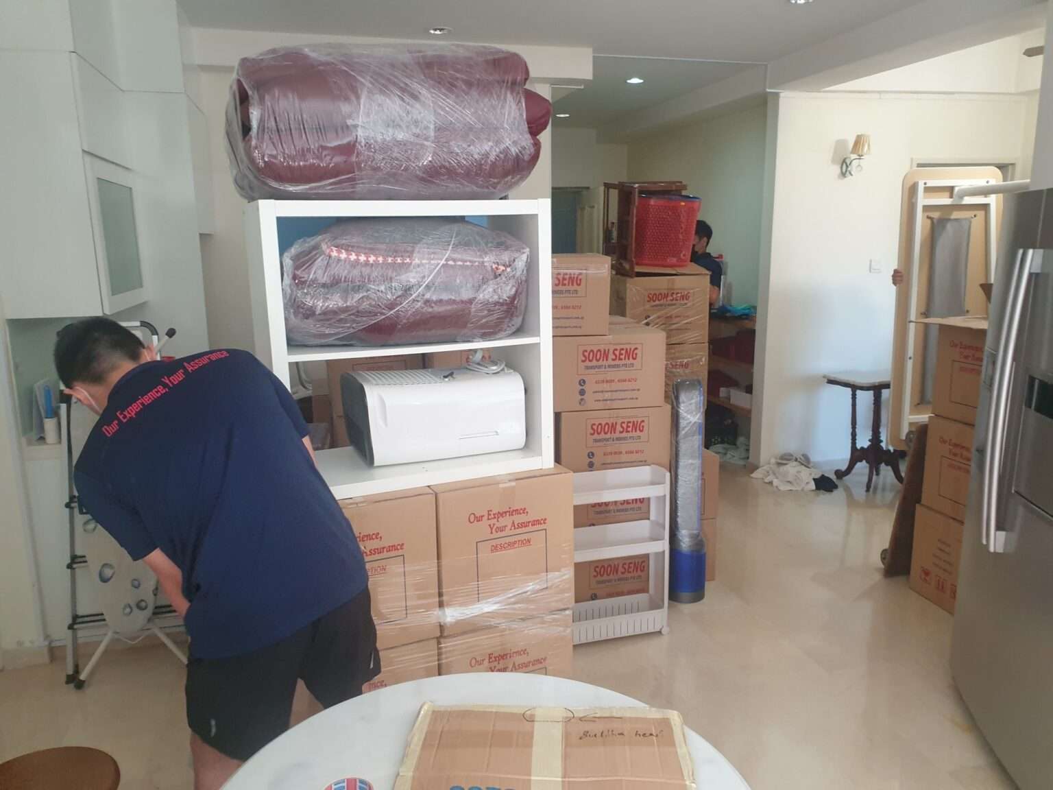 mover wrapping and packing items in boxes before moving to new house