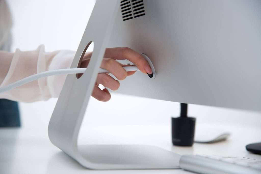 employee unplugging computer power for moving
