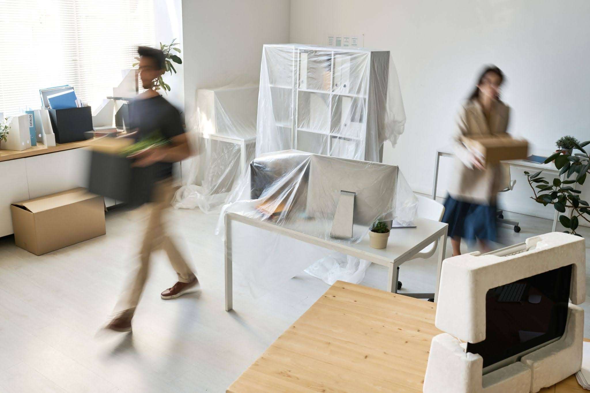 movers packing up office furniture and equipments